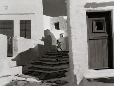 Henri-Cartier-Bresson-A-figure-in-the-shadows-at-the-top-of-the-stairs,-Cyclades,-Greece-1961